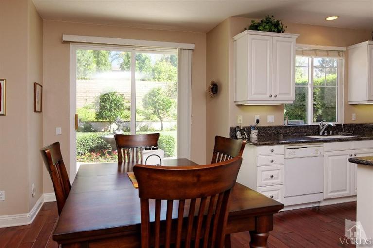 287 Knoll Ridge Road Simi Valley, CA 93065 - Photo 19 of 36 a kitchen with a table chairs and wooden floor