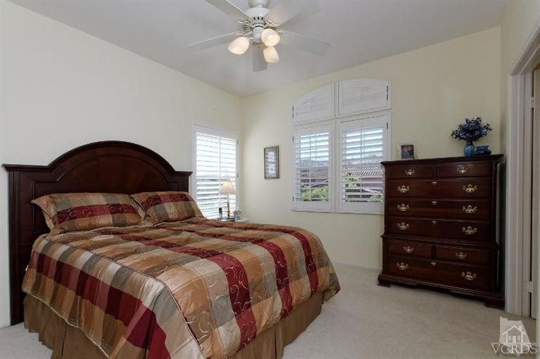 287 Knoll Ridge Road Simi Valley, CA 93065 - Photo 24 of 36 a bedroom with a bed a lamp and a dresser