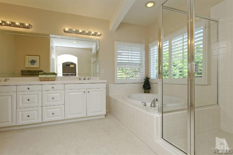 287 Knoll Ridge Road Simi Valley, CA 93065 - Photo 26 of 36 a bathroom with a granite countertop sink mirror bathtub and next to a window