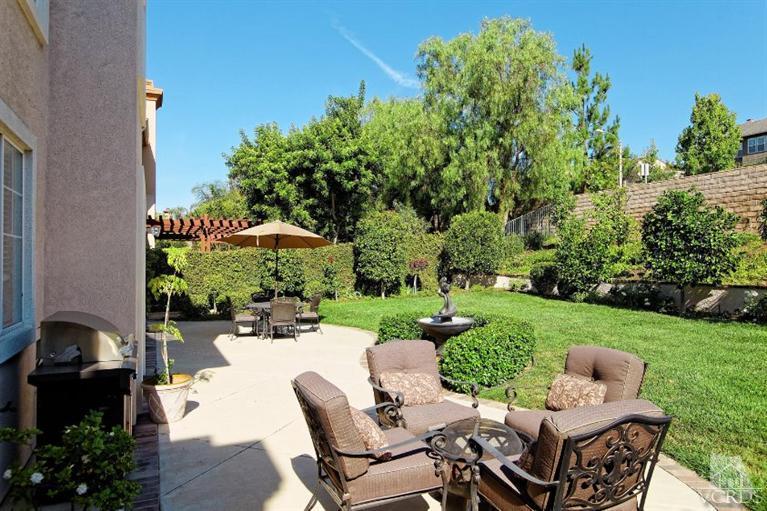 287 Knoll Ridge Road Simi Valley, CA 93065 - Photo 35 of 36 a view of a patio with a table chairs and a garden