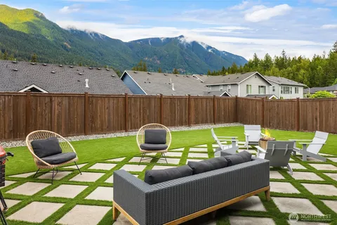 a backyard of a house with table and chairs