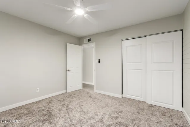 a view of kitchen with granite countertop cabinets and refrigerator