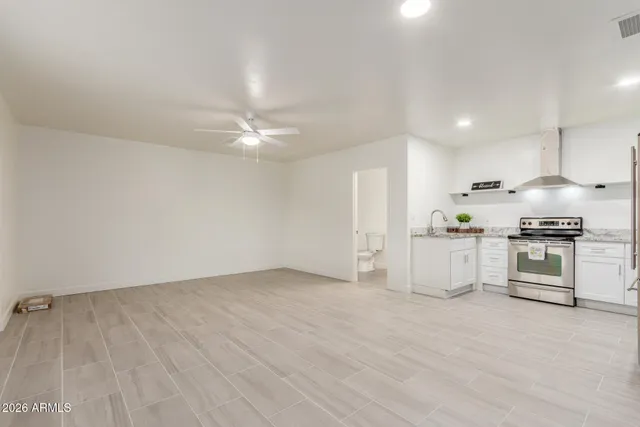 a bathroom with a toilet sink vanity tub and mirror