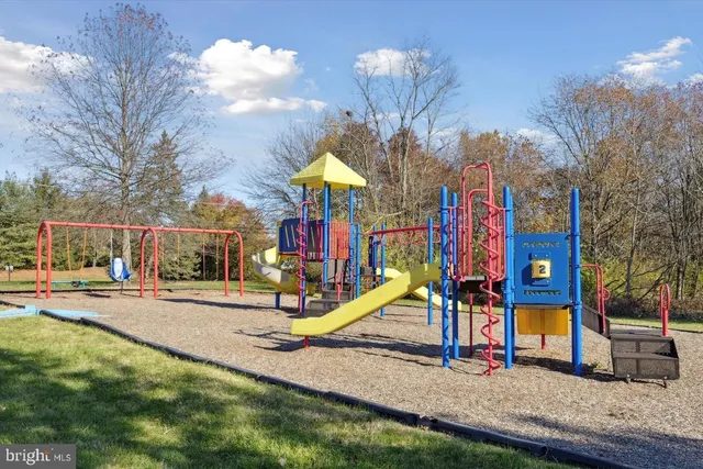 a view of a park with slide and a table