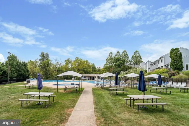 a swimming pool with outdoor seating and yard