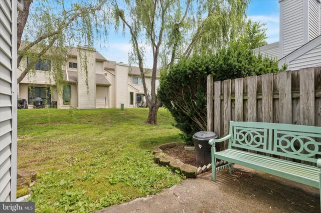 a view of a bench in a back yard