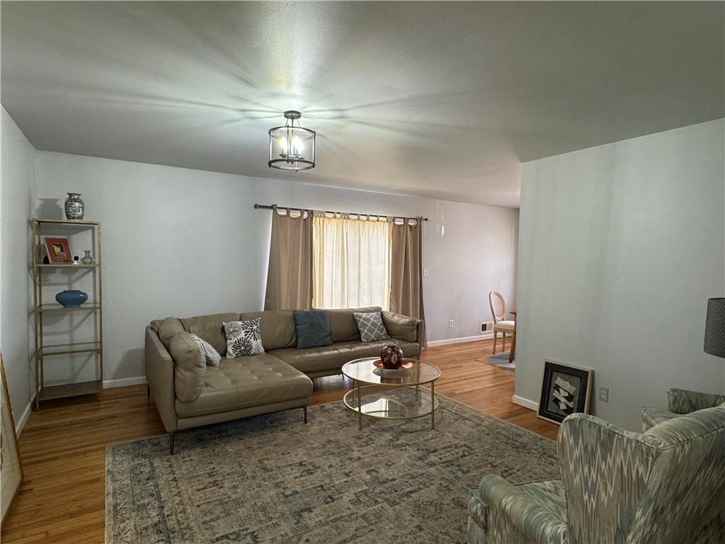 3080 Forrest Park Road Southeast Atlanta, GA 30354 - Photo 6 of 17 a living room with furniture and a chandelier