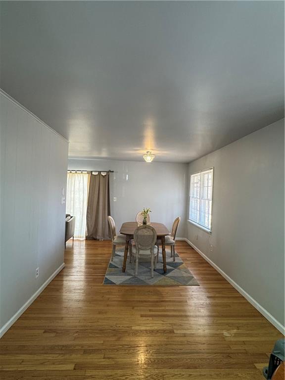 3080 Forrest Park Road Southeast Atlanta, GA 30354 - Photo 7 of 17 a dining room with furniture wooden floor a rug and a painting