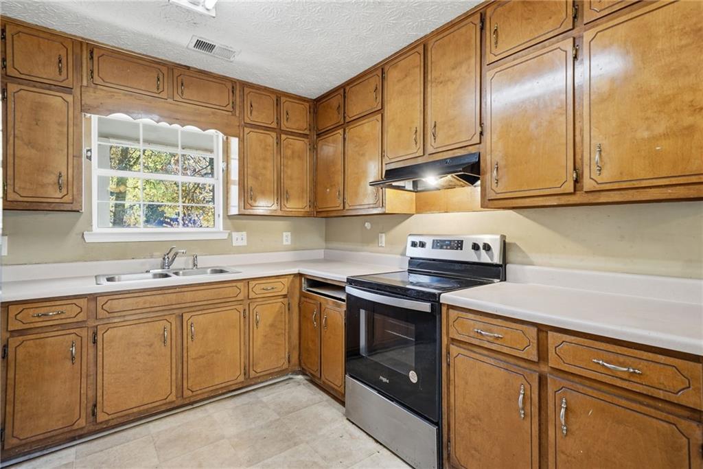 255 Countryside Lane Covington, GA 30016 - Photo 14 of 35 a kitchen with a sink cabinets and window