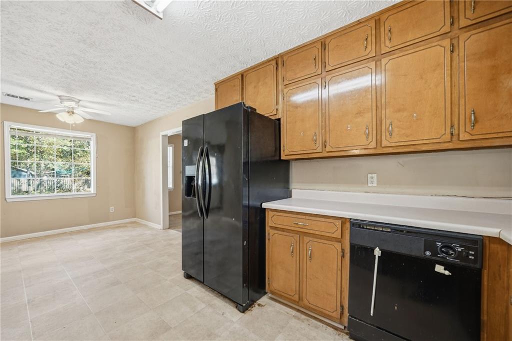 255 Countryside Lane Covington, GA 30016 - Photo 16 of 35 a kitchen with stainless steel appliances granite countertop a refrigerator and a sink