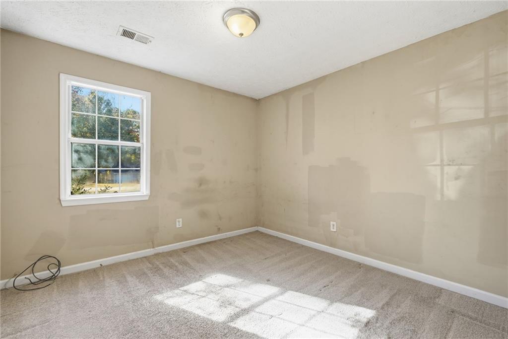 255 Countryside Lane Covington, GA 30016 - Photo 19 of 35 an empty room with a window