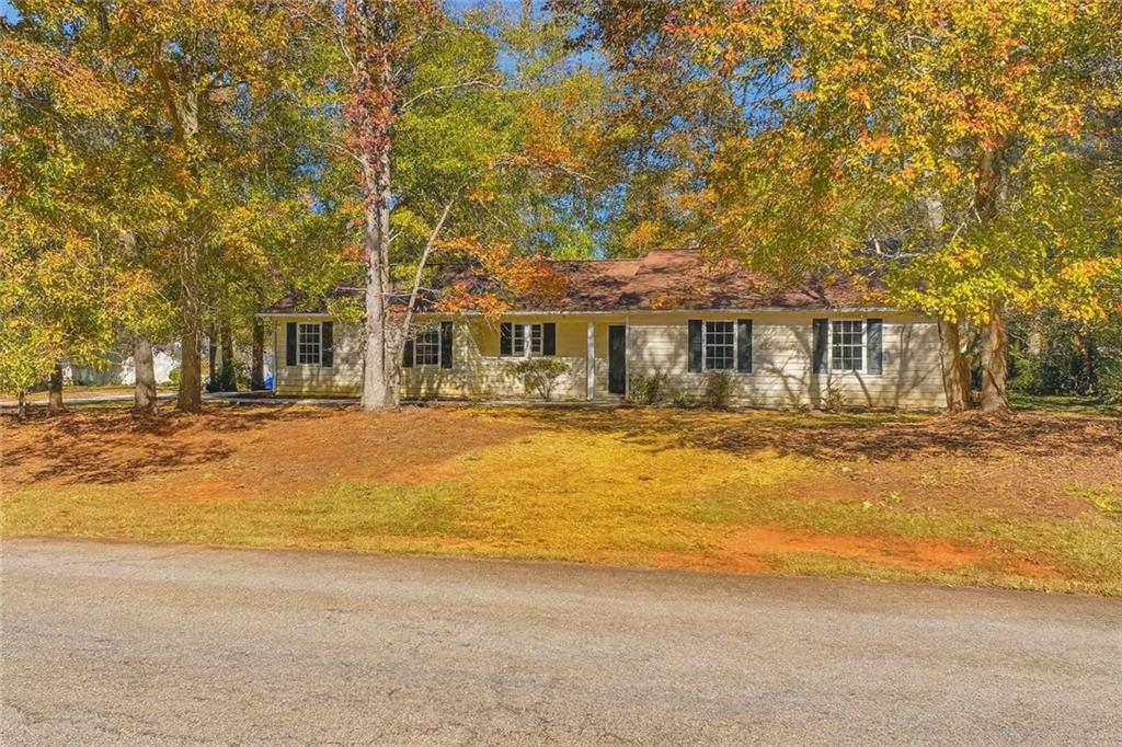 255 Countryside Lane Covington, GA 30016 - Photo 2 of 35 a front view of a building with a yard