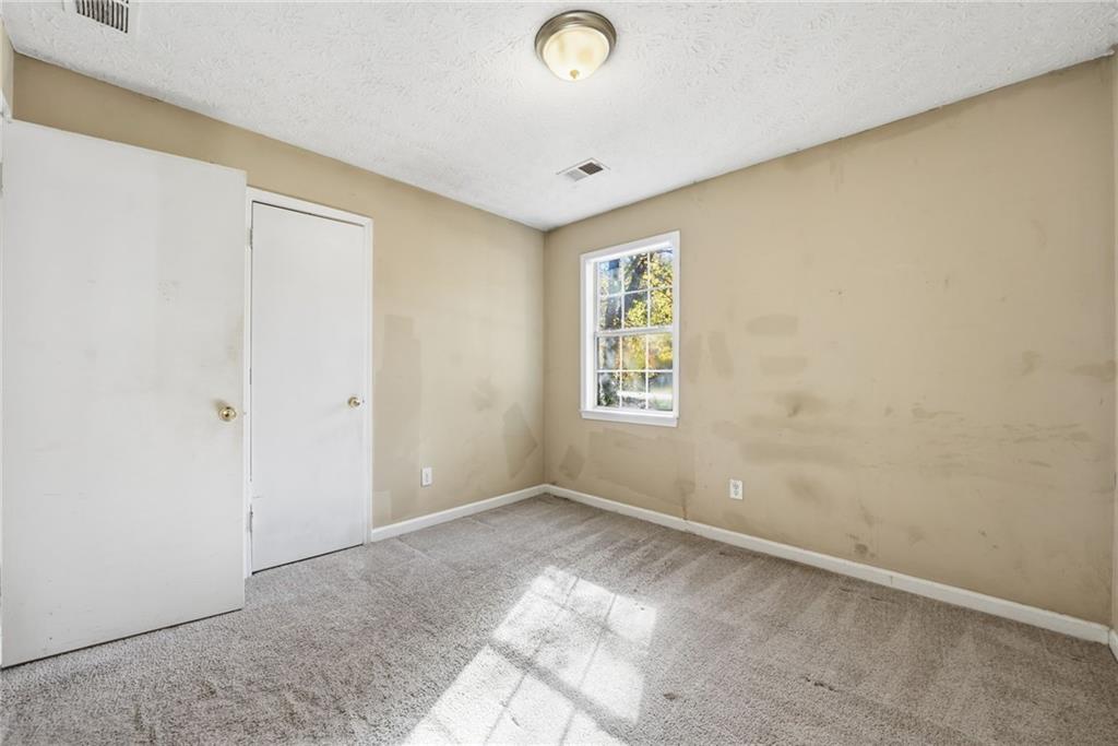 255 Countryside Lane Covington, GA 30016 - Photo 21 of 35 an empty room with windows and closet