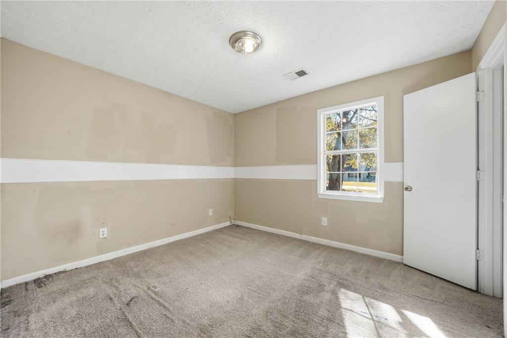 255 Countryside Lane Covington, GA 30016 - Photo 23 of 35 an empty room with windows