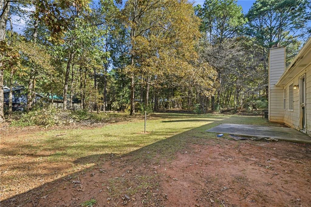 255 Countryside Lane Covington, GA 30016 - Photo 29 of 35 a view of a swimming pool with a yard and large trees