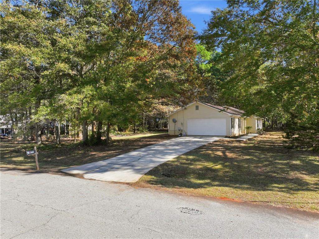 255 Countryside Lane Covington, GA 30016 - Photo 3 of 35 a front view of a house with a yard and garage
