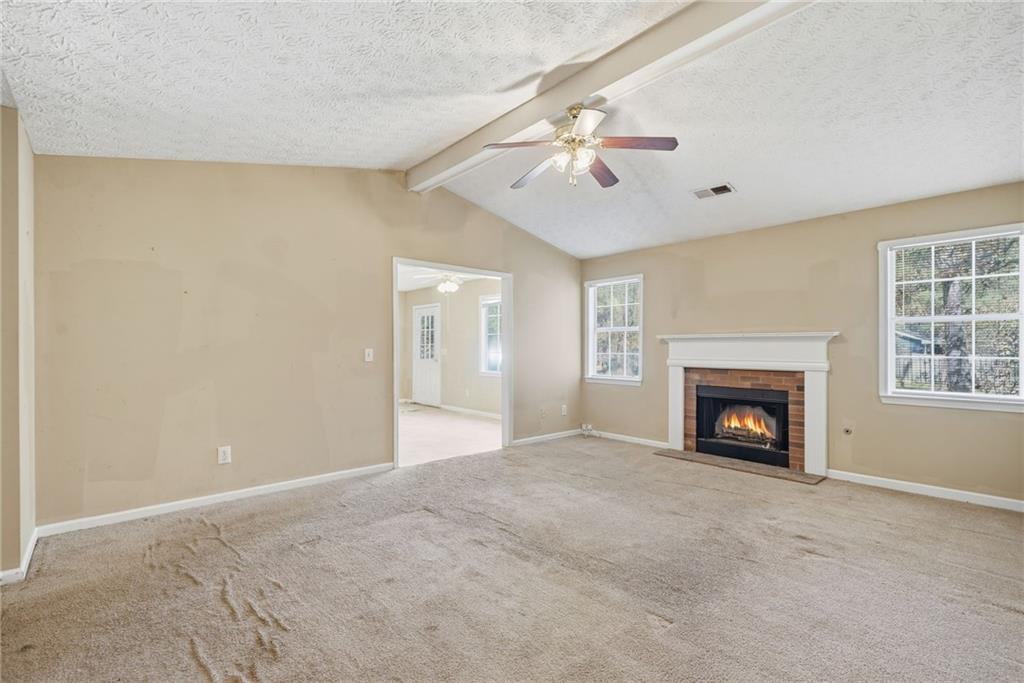 255 Countryside Lane Covington, GA 30016 - Photo 6 of 35 a view of an empty room with a fireplace and a window