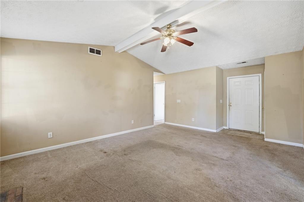255 Countryside Lane Covington, GA 30016 - Photo 8 of 35 a view of an empty room with chandelier fan