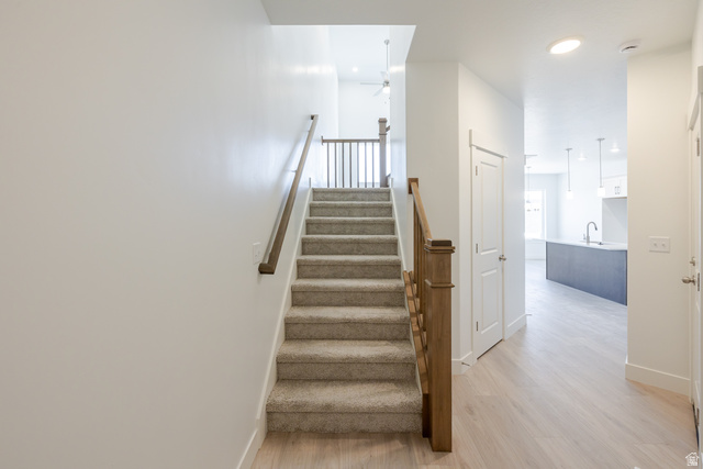 4720 Heartwood Road, Unit 438 Mapleton, UT 84664 - Photo 11 of 19 Staircase with wood finished floors, a ceiling fan, and recessed lighting