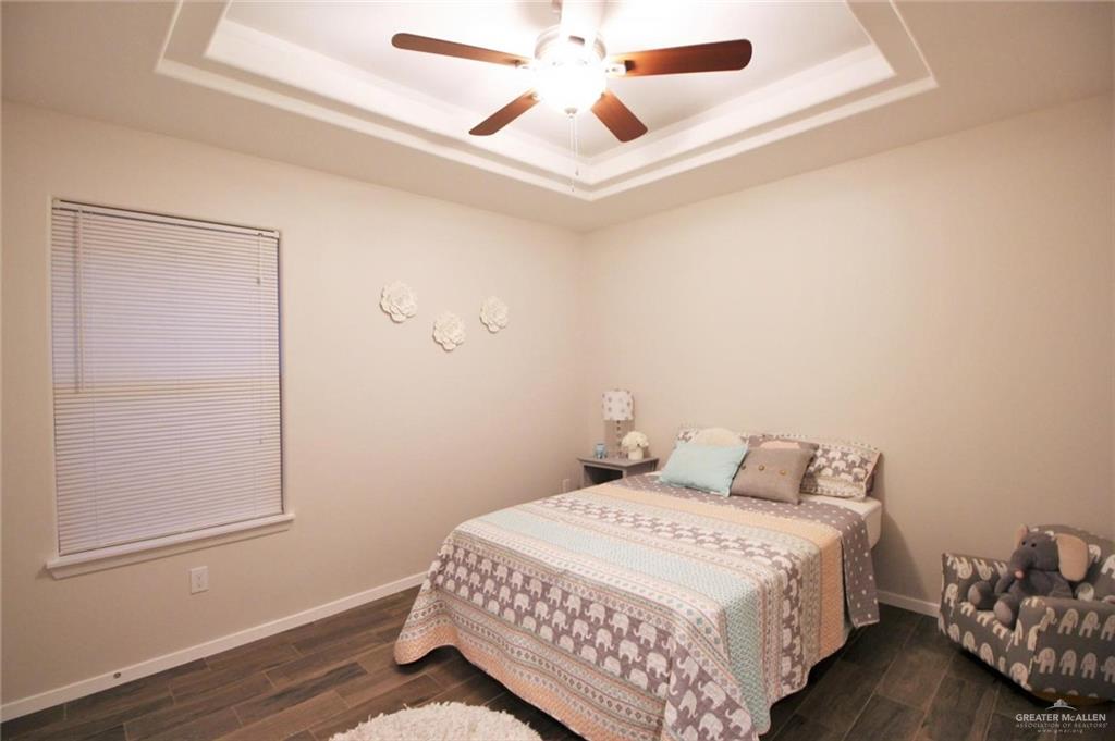 1507 Coyote Hills, Unit 4 Edinburg, TX 78541 - Photo 7 of 12 a bedroom with a bed and a ceiling fan