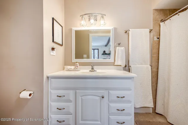 a bathroom with a granite countertop toilet sink and mirror
