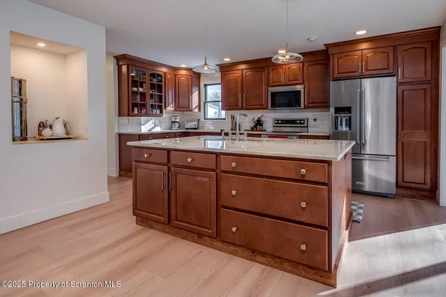 a bathroom with a granite countertop toilet sink and mirror