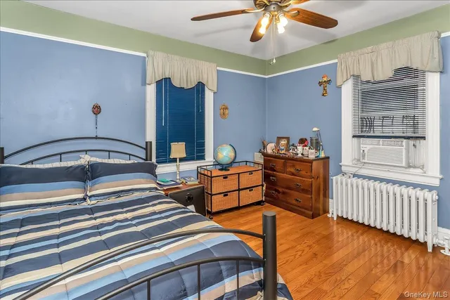 a bedroom with furniture and wooden floor
