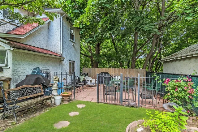 a view of a chair and table in back yard of the house