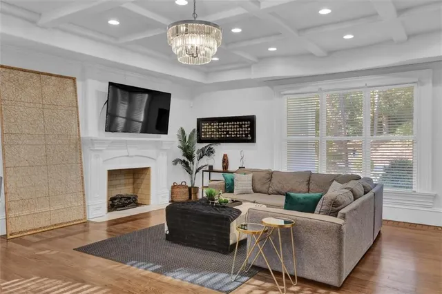 a living room with furniture fireplace and a table