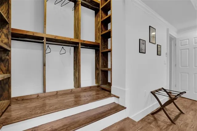 a spacious bedroom with a bed and a large window