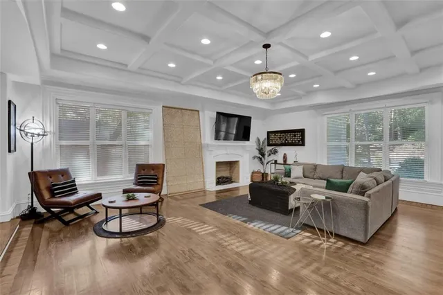 a living room with furniture a fireplace and a flat screen tv