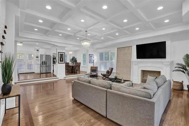 a living room with furniture a fireplace and a flat screen tv