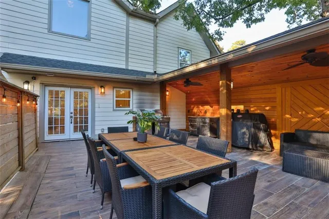 a bedroom with a bed a chair and potted plant on the dresser