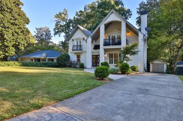 a view of a dining room with furniture a chandelier and wooden floor