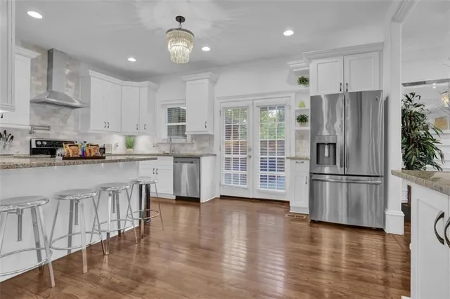 a kitchen with a sink window and refrigerator