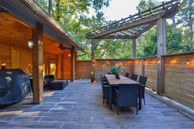 a view of a livingroom with furniture and floor to ceiling window