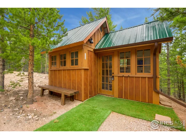 a view of backyard with deck and garden