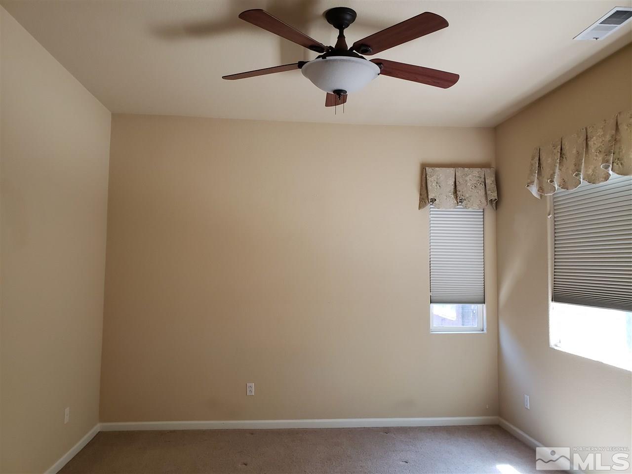 1680 Emerald Bay Drive Reno, NV 89521 - Photo 13 of 27 an empty room with windows and fan