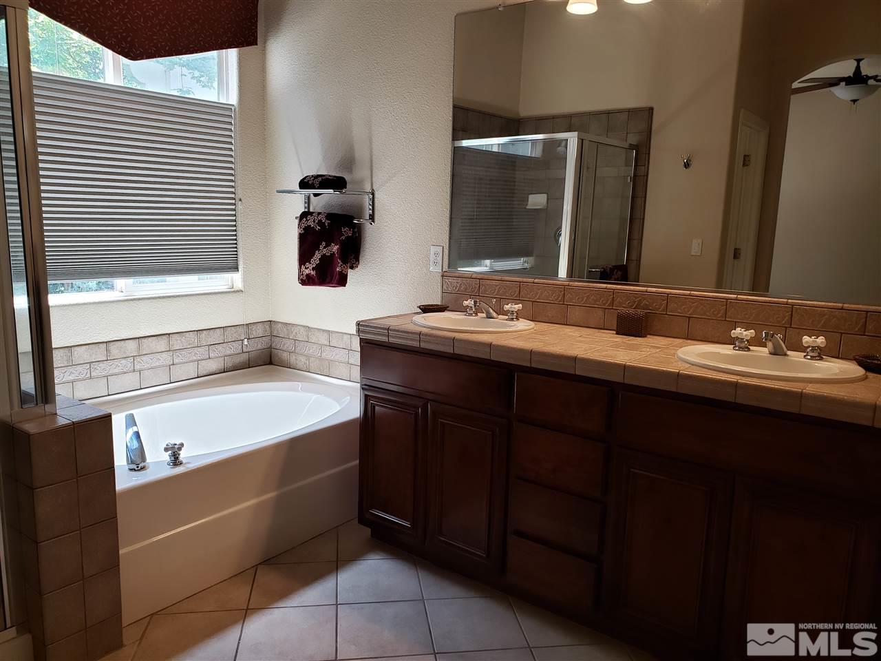 1680 Emerald Bay Drive Reno, NV 89521 - Photo 14 of 27 a bathroom with a tub sink and mirror