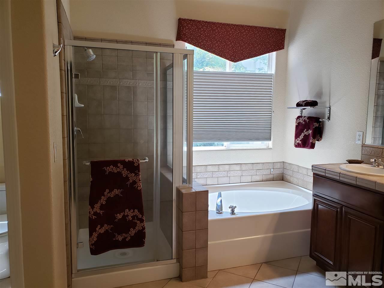 1680 Emerald Bay Drive Reno, NV 89521 - Photo 15 of 27 a bathroom with a bathtub and a shower