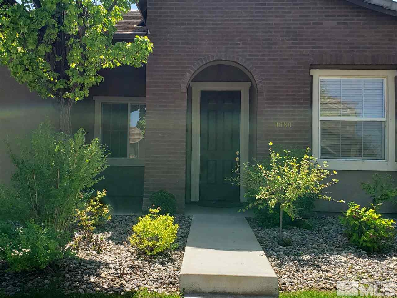 1680 Emerald Bay Drive Reno, NV 89521 - Photo 3 of 27 a front view of a house with a yard