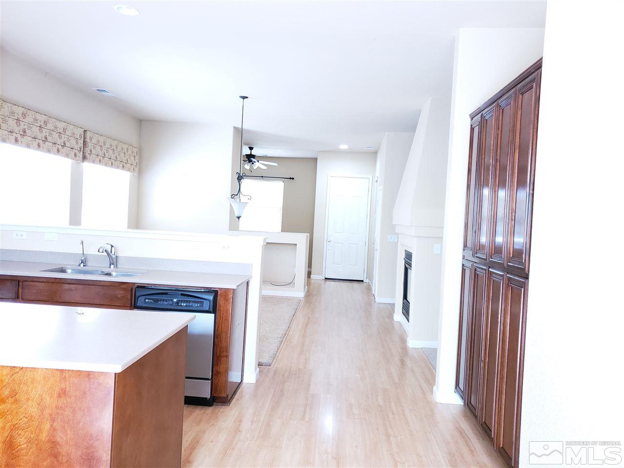 1680 Emerald Bay Drive Reno, NV 89521 - Photo 4 of 27 a kitchen with granite countertop a sink stove and refrigerator