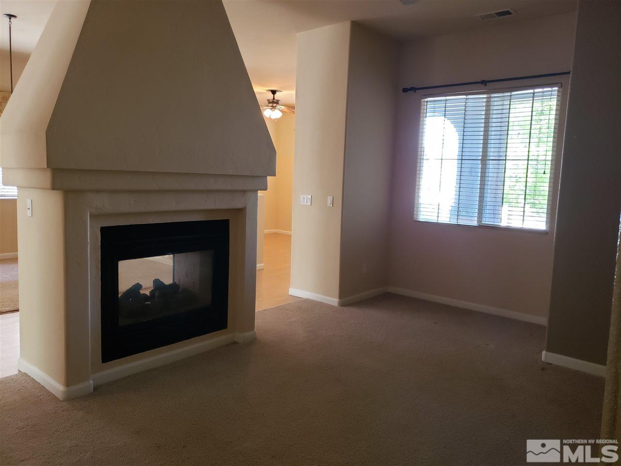 1680 Emerald Bay Drive Reno, NV 89521 - Photo 9 of 27 an empty room with a fireplace