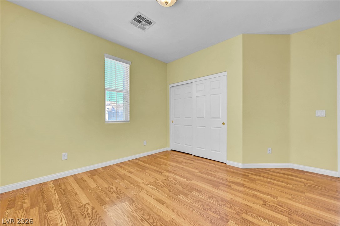 977 Sparkling Light Street Henderson, NV 89052 - Photo 53 of 75 This spacious room features bright walls and polished wood flooring.