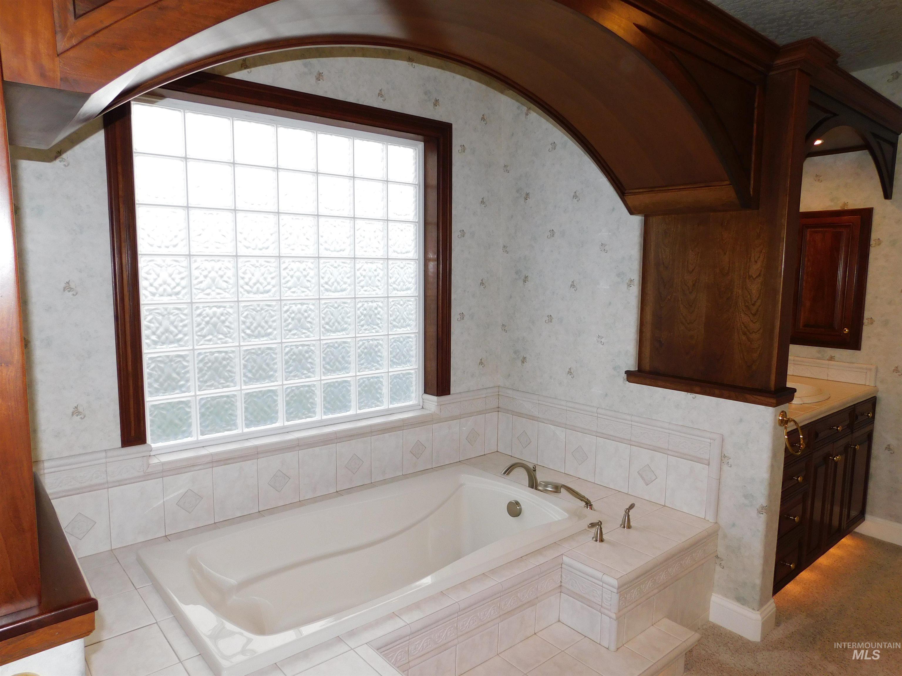 17777 Allendale Road Wilder, ID 83676 - Photo 17 of 50 Bathroom with wallpapered walls, a bath, and vanity