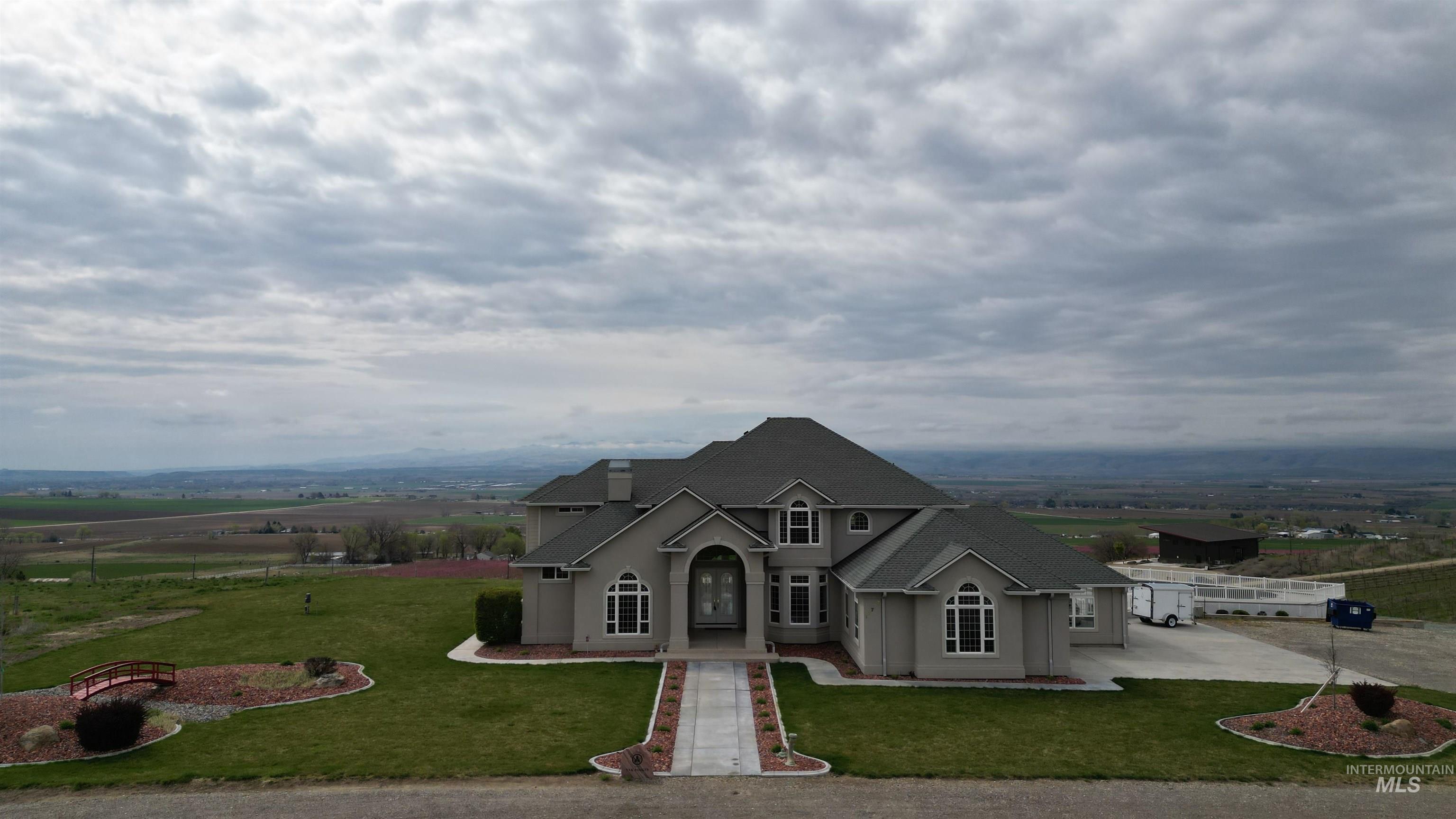 17777 Allendale Road Wilder, ID 83676 - Photo 3 of 50 Traditional-style house featuring a front lawn, stucco siding, and a shingled roof
