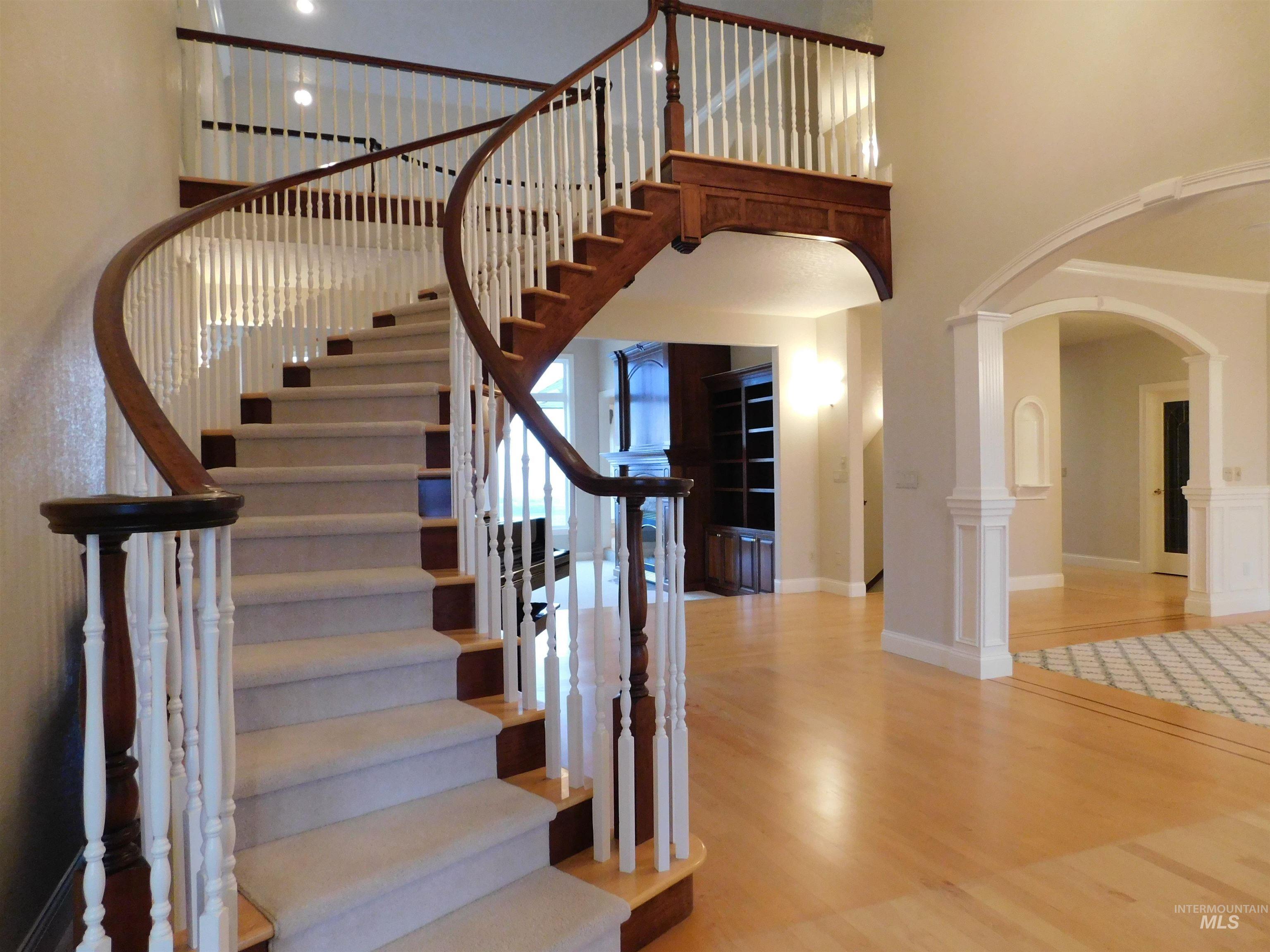 17777 Allendale Road Wilder, ID 83676 - Photo 5 of 50 Stairway featuring arched walkways, hard wood floors, and a high ceiling