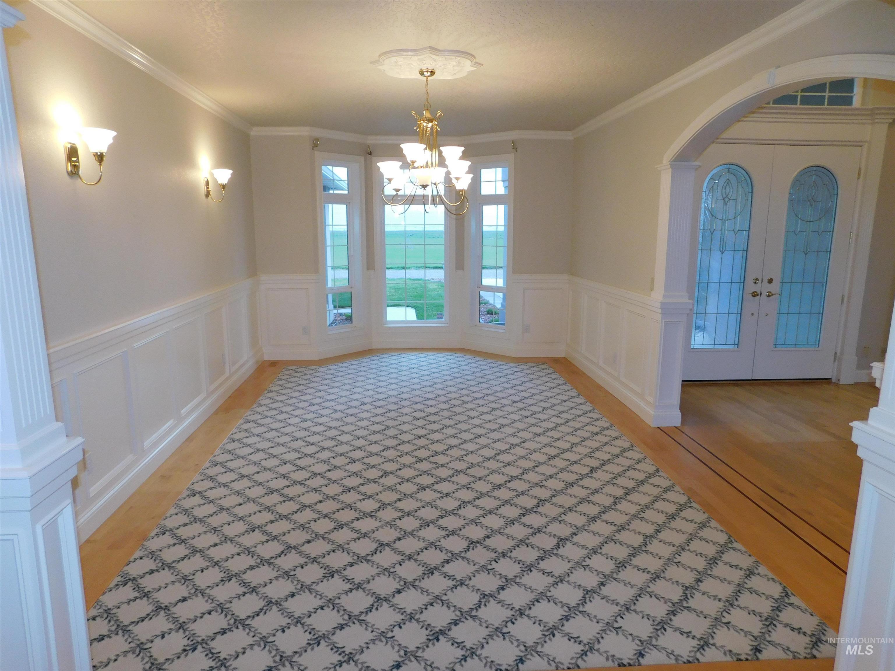 17777 Allendale Road Wilder, ID 83676 - Photo 6 of 50 Arched walkways, ornamental molding, suspended lighting, and decorative columns