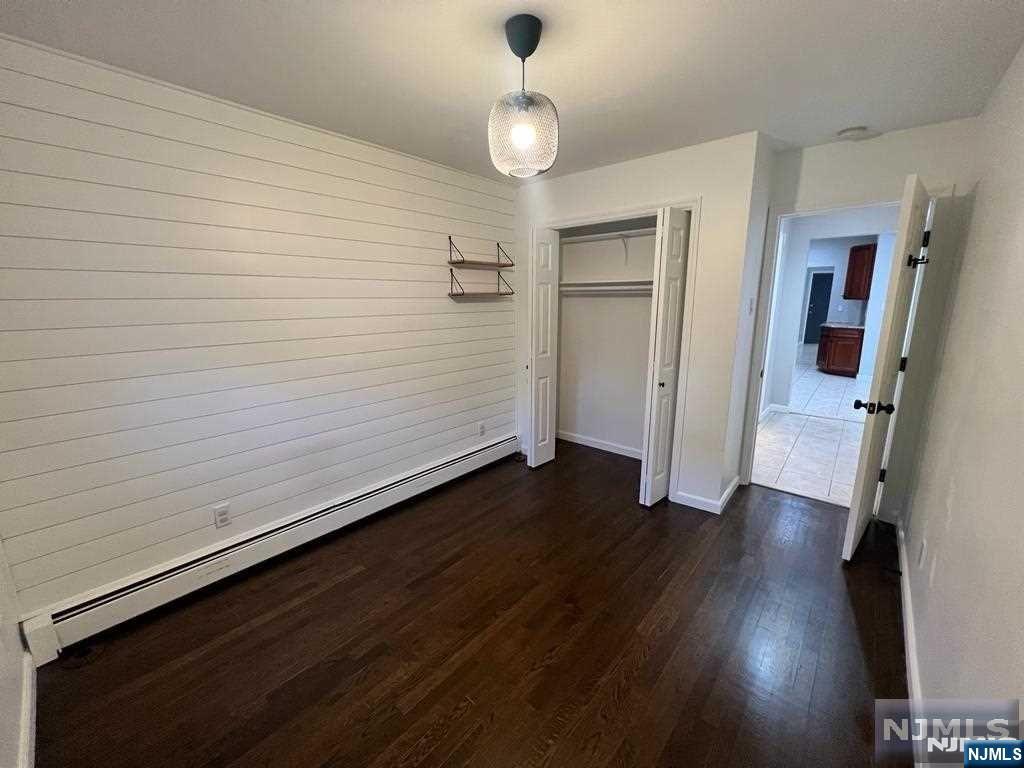 493 Morningside Avenue, Unit 2 Fairview, NJ 07022 - Photo 4 of 9 wooden floor in an empty room with a window