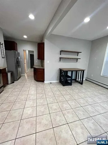a large room with a table and a stove top oven